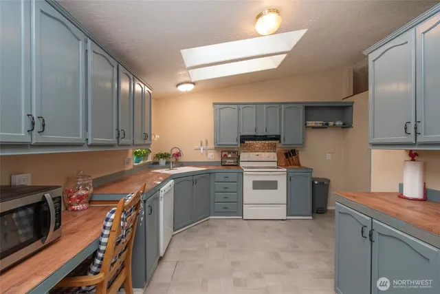 a kitchen with a sink stove and cabinets