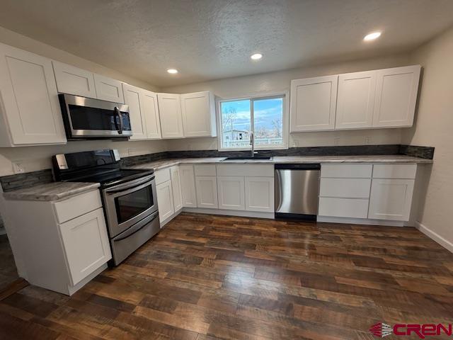 783 1550th Road Delta, CO 81416 - Photo 14 of 23 a kitchen with stainless steel appliances granite countertop a stove a sink and a microwave