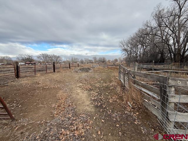 783 1550th Road Delta, CO 81416 - Photo 9 of 23 a view of a dry yard with wooden fence