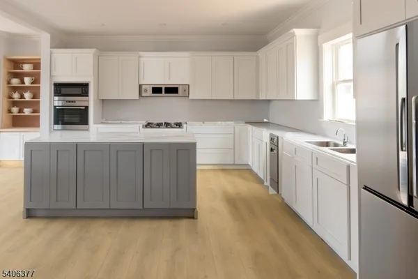 a kitchen with cabinets and stainless steel appliances
