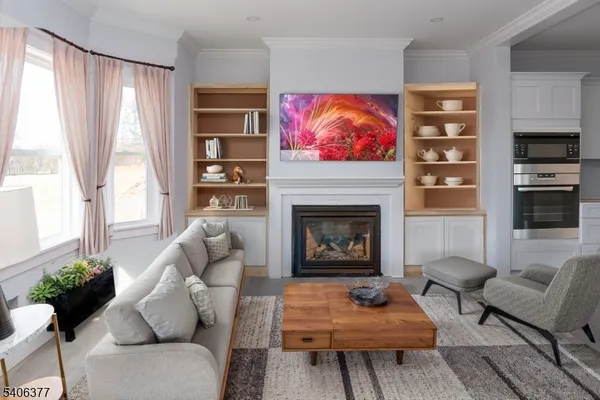 a living room with furniture a flat screen tv and a fireplace
