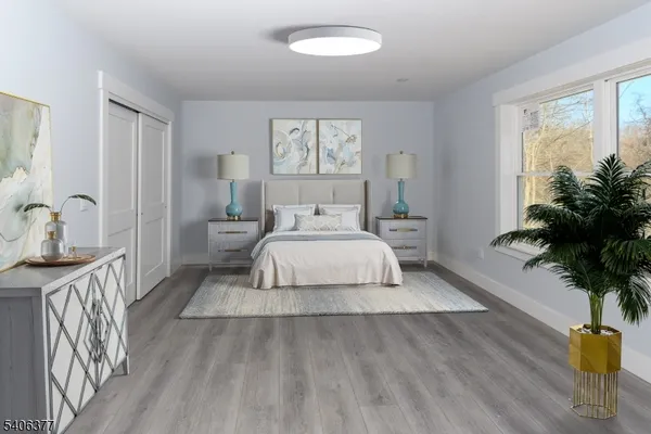 a room with a bed and a large window