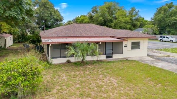 a view of a house with pool and garden