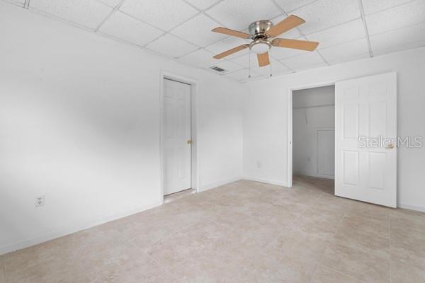 1404 East Alfred Street Tavares, FL 32778 - Photo 12 of 38 an empty room with ceiling fan and window