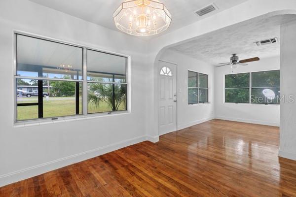 1404 East Alfred Street Tavares, FL 32778 - Photo 21 of 38 an empty room with wooden floor and windows