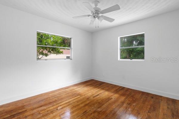 1404 East Alfred Street Tavares, FL 32778 - Photo 27 of 38 a view of an empty room with wooden floor and a window