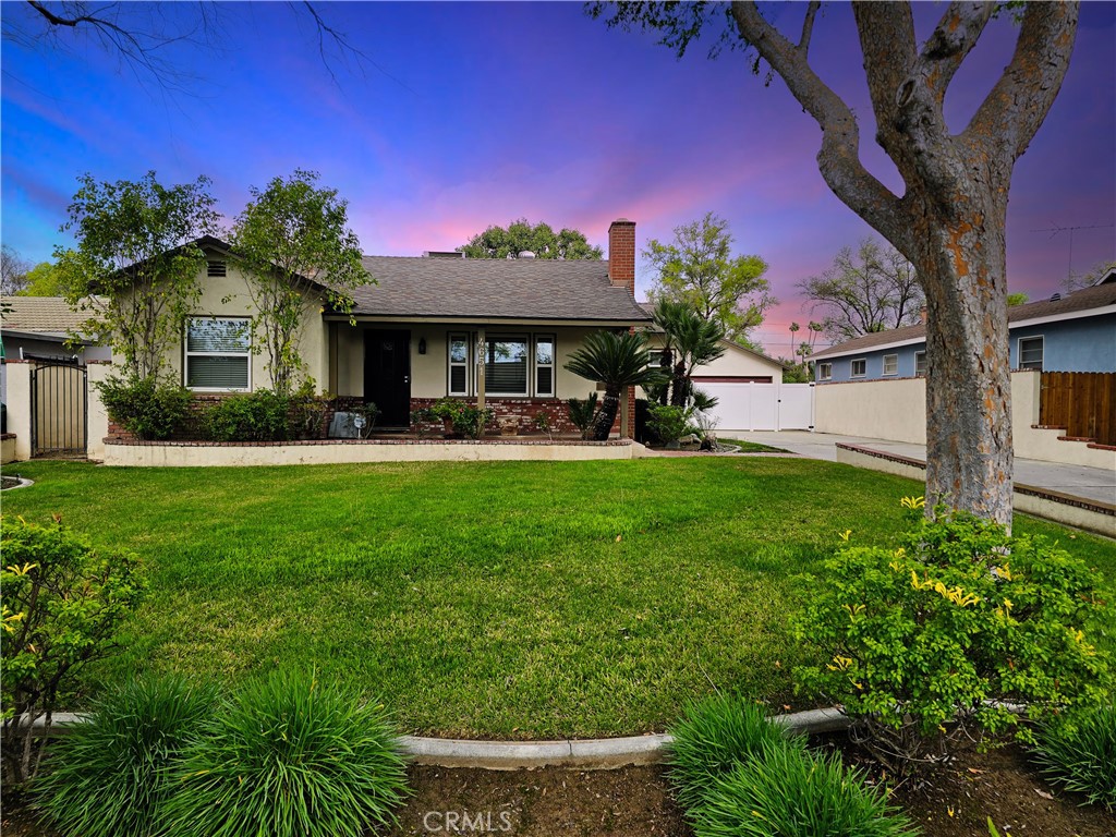 a front view of a house with a yard garage and outdoor seating