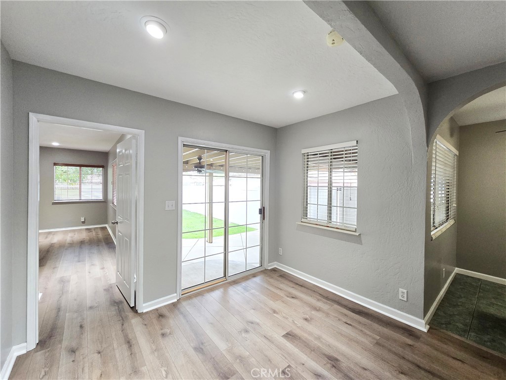 4651 Emerson Street Riverside, CA 92506 - Photo 14 of 32 an empty room with wooden floor and windows
