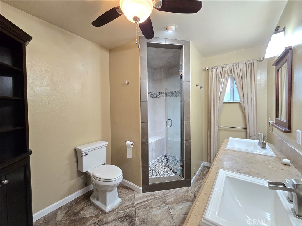 4651 Emerson Street Riverside, CA 92506 - Photo 17 of 32 a bathroom with a toilet sink and shower