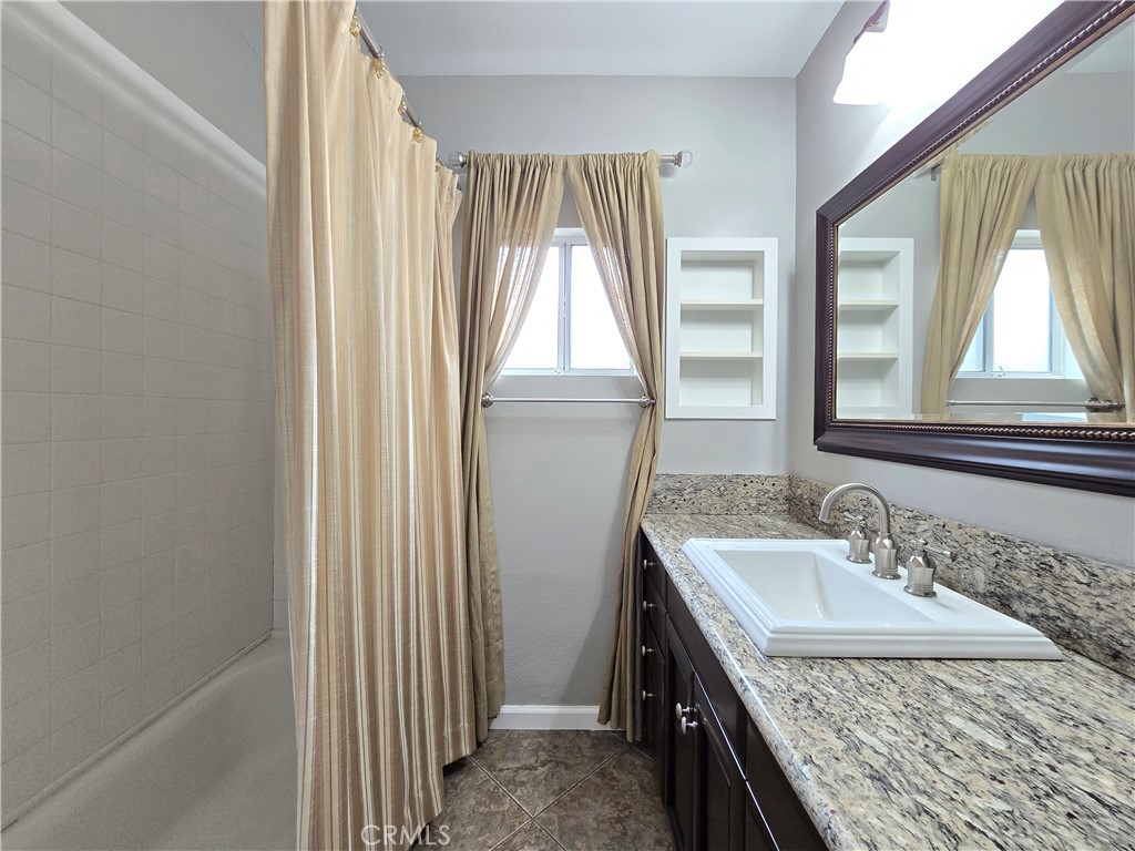 4651 Emerson Street Riverside, CA 92506 - Photo 23 of 32 a bathroom with a granite countertop sink and a window