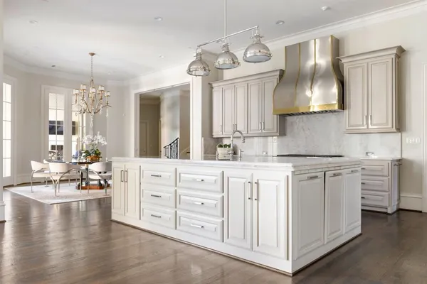a kitchen with stainless steel appliances a stove a sink and a refrigerator