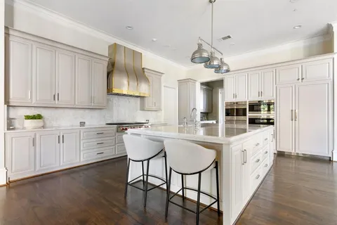 a kitchen with stove a sink and cabinets