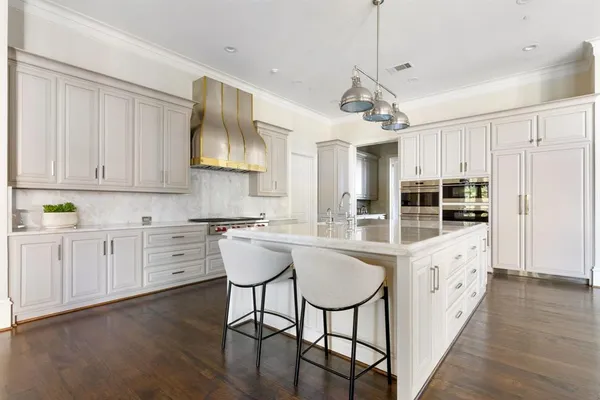 a kitchen with stove a sink and cabinets