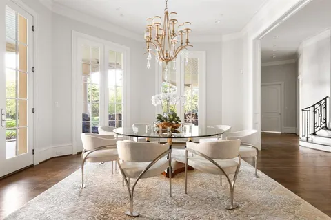 a living room with furniture and large windows