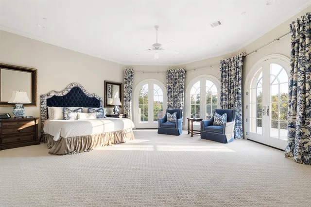 a spacious bedroom with a bed couch and a window