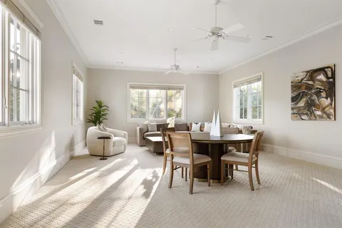 a view of a building with a porch and furniture