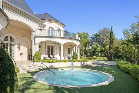 a front view of a building with a garden