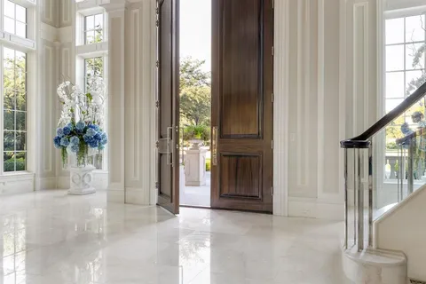 a view of an entryway with wooden floor and door