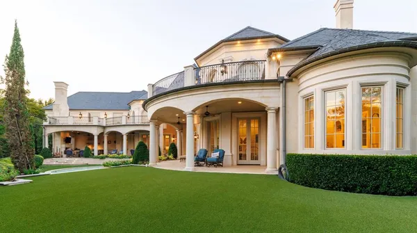 a view of a house with swimming pool and a small yard