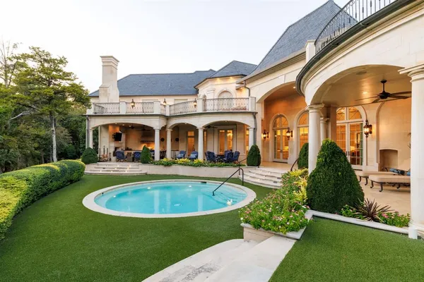 a view of a house with swimming pool and a yard