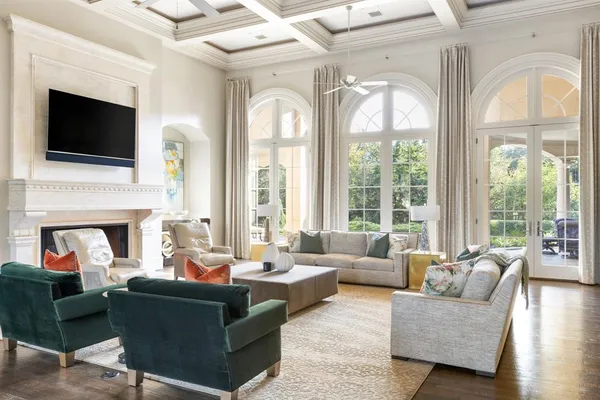 a living room with furniture a fireplace and a flat screen tv