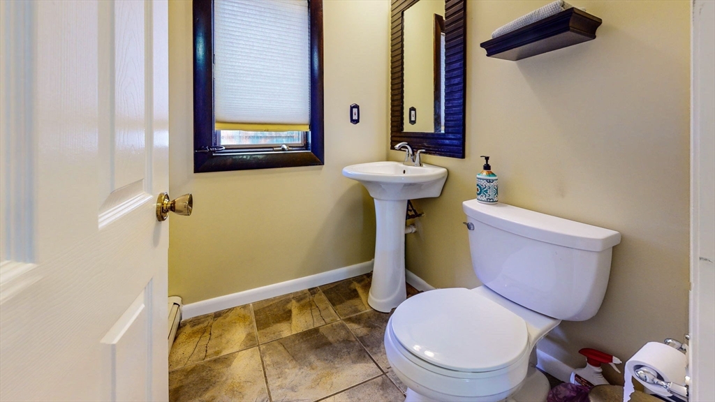 15 Carlin Road Waltham, MA 02451 - Photo 14 of 42 a white toilet sitting next to a bathroom sink