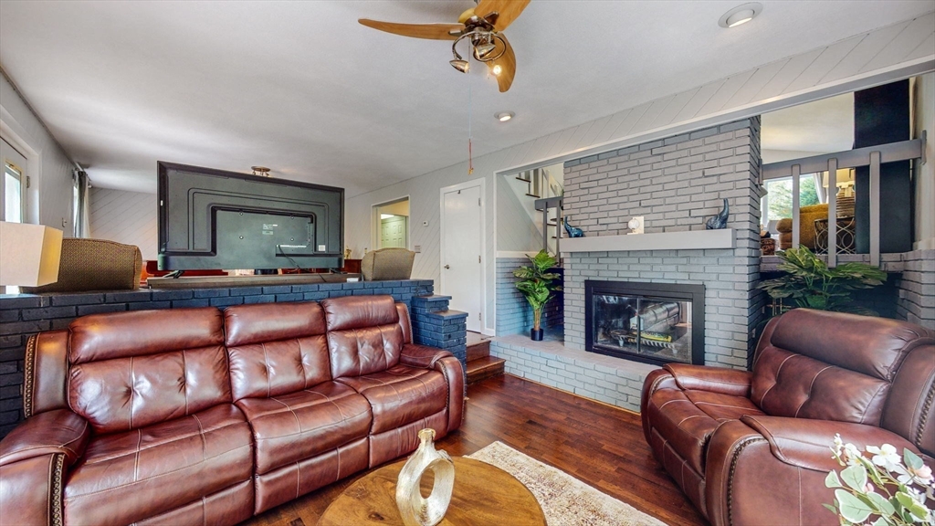 15 Carlin Road Waltham, MA 02451 - Photo 19 of 42 a living room with furniture and a fireplace