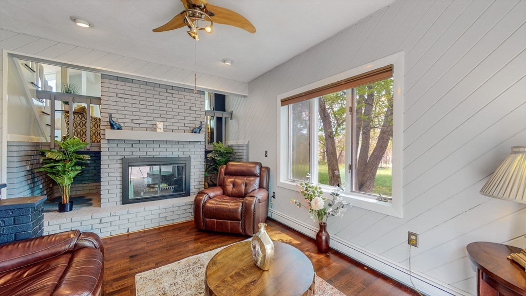 15 Carlin Road Waltham, MA 02451 - Photo 20 of 42 a living room with furniture and a fireplace