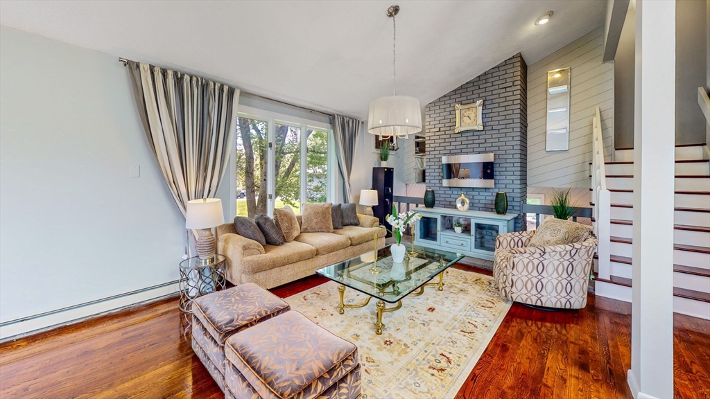 15 Carlin Road Waltham, MA 02451 - Photo 2 of 42 a living room with furniture fireplace and a large window