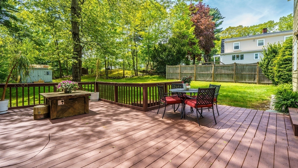 15 Carlin Road Waltham, MA 02451 - Photo 23 of 42 a view of a patio with a dining table and chairs with wooden floor