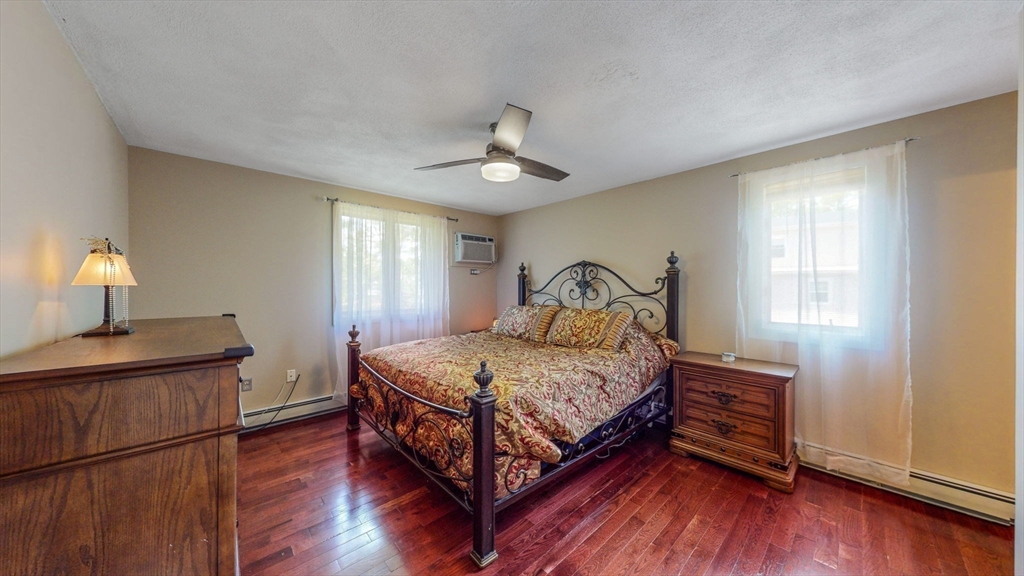 15 Carlin Road Waltham, MA 02451 - Photo 25 of 42 a bedroom with a bed and wooden floor