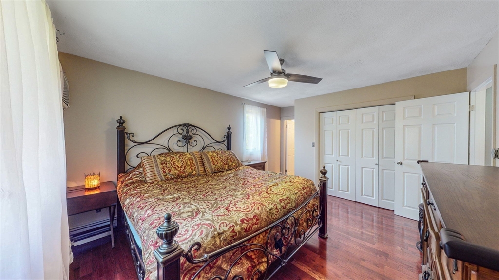 15 Carlin Road Waltham, MA 02451 - Photo 26 of 42 a bedroom with a bed a dresser and wooden floor
