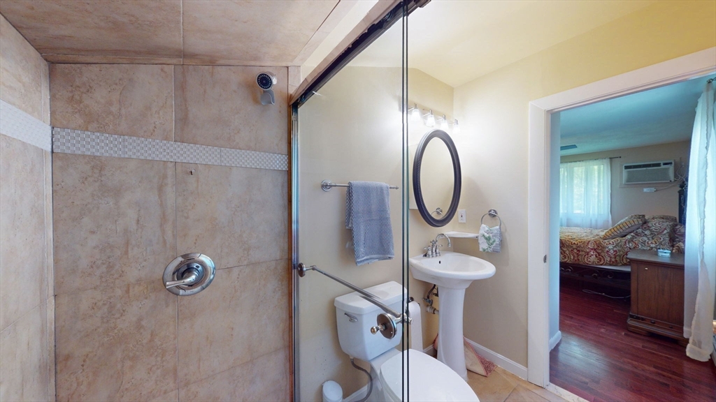 15 Carlin Road Waltham, MA 02451 - Photo 28 of 42 a bathroom with a sink mirror toilet and shower