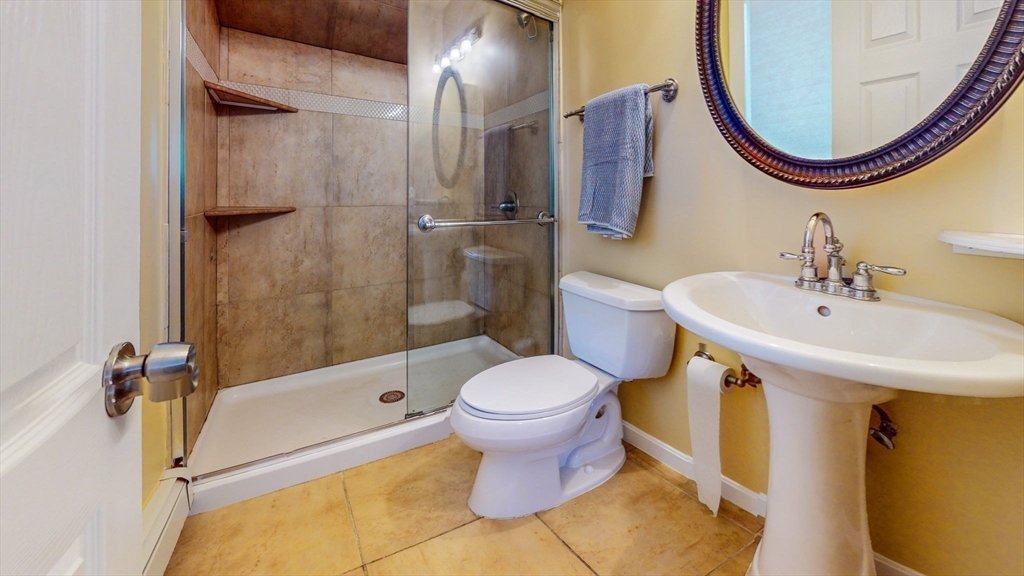 15 Carlin Road Waltham, MA 02451 - Photo 29 of 42 a bathroom with a sink and a mirror
