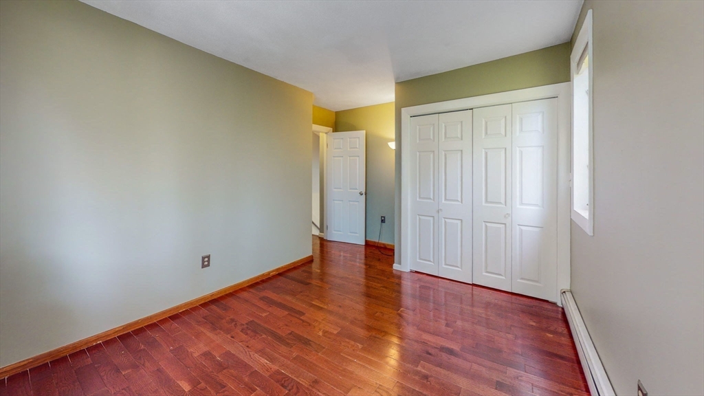 15 Carlin Road Waltham, MA 02451 - Photo 31 of 42 a view of an empty room with wooden floor