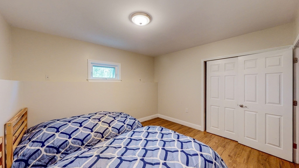 15 Carlin Road Waltham, MA 02451 - Photo 35 of 42 a bedroom with a bed and a wooden floor