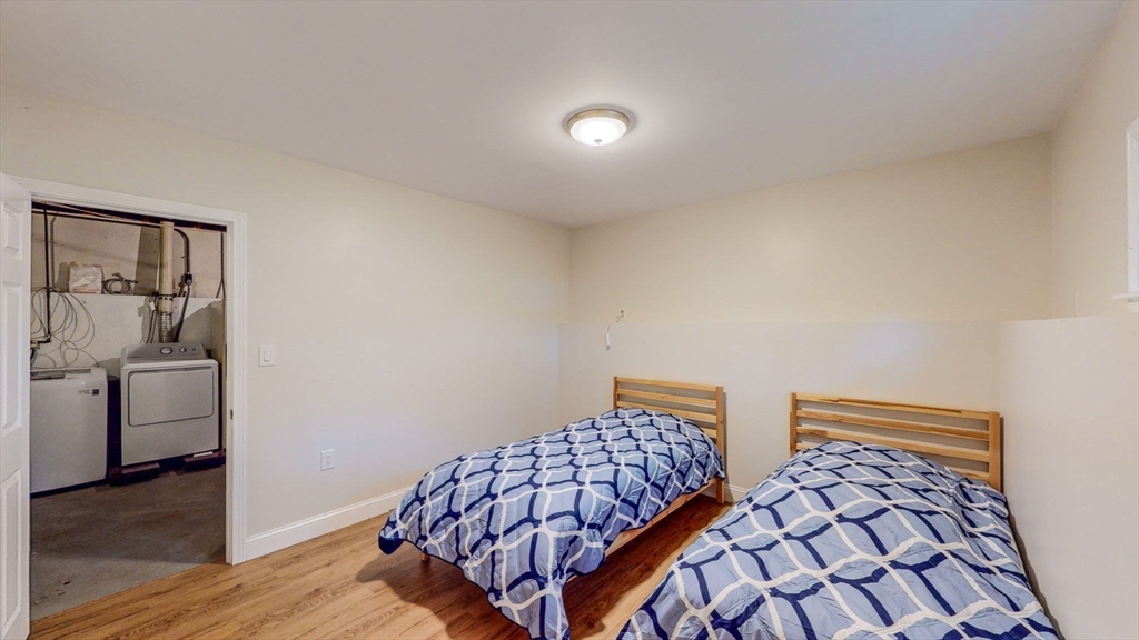 15 Carlin Road Waltham, MA 02451 - Photo 36 of 42 a bedroom with a bed and wooden floor