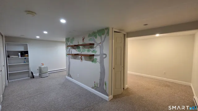 a view of empty room with wooden floor and window