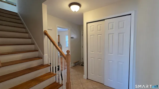 a view of entryway with wooden floor and stairs
