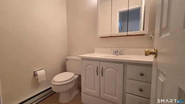 a bathroom with a sink a toilet and mirror
