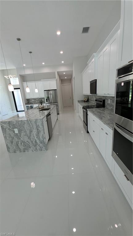563 15th Street Northwest Naples, FL 34120 - Photo 10 of 22 a large white kitchen with a large window