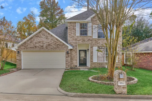a front view of house with yard and trees