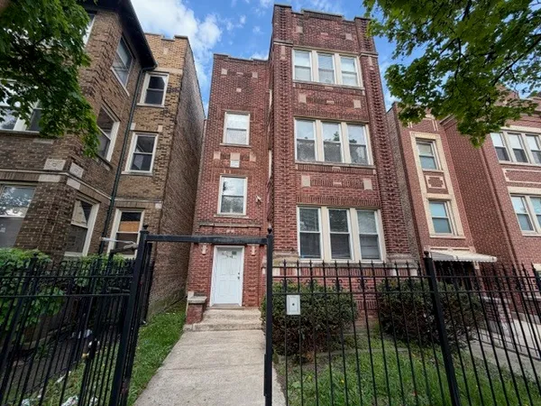 a front view of a multi story building with a yard