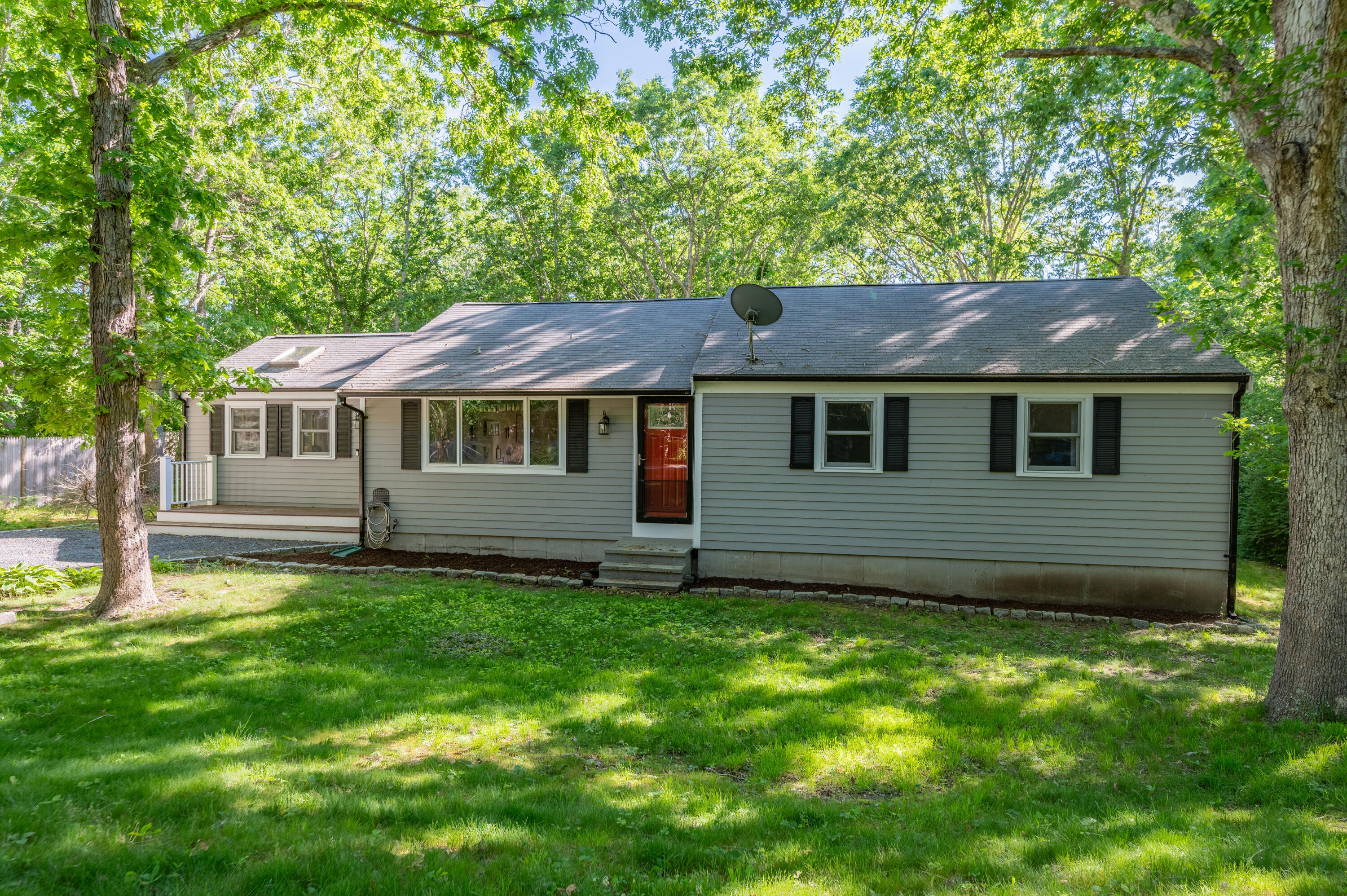 292 Jones Road Marstons Mills, MA 02648 - Photo 24 of 38 a front view of a house with a garden