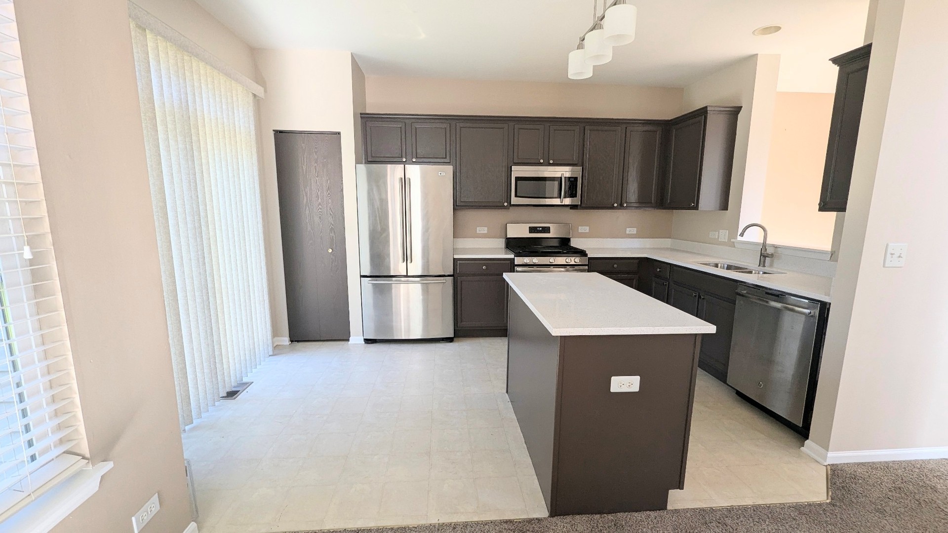 2075 Village View Drive Yorkville, IL 60560 - Photo 4 of 15 a kitchen with a sink refrigerator and microwave