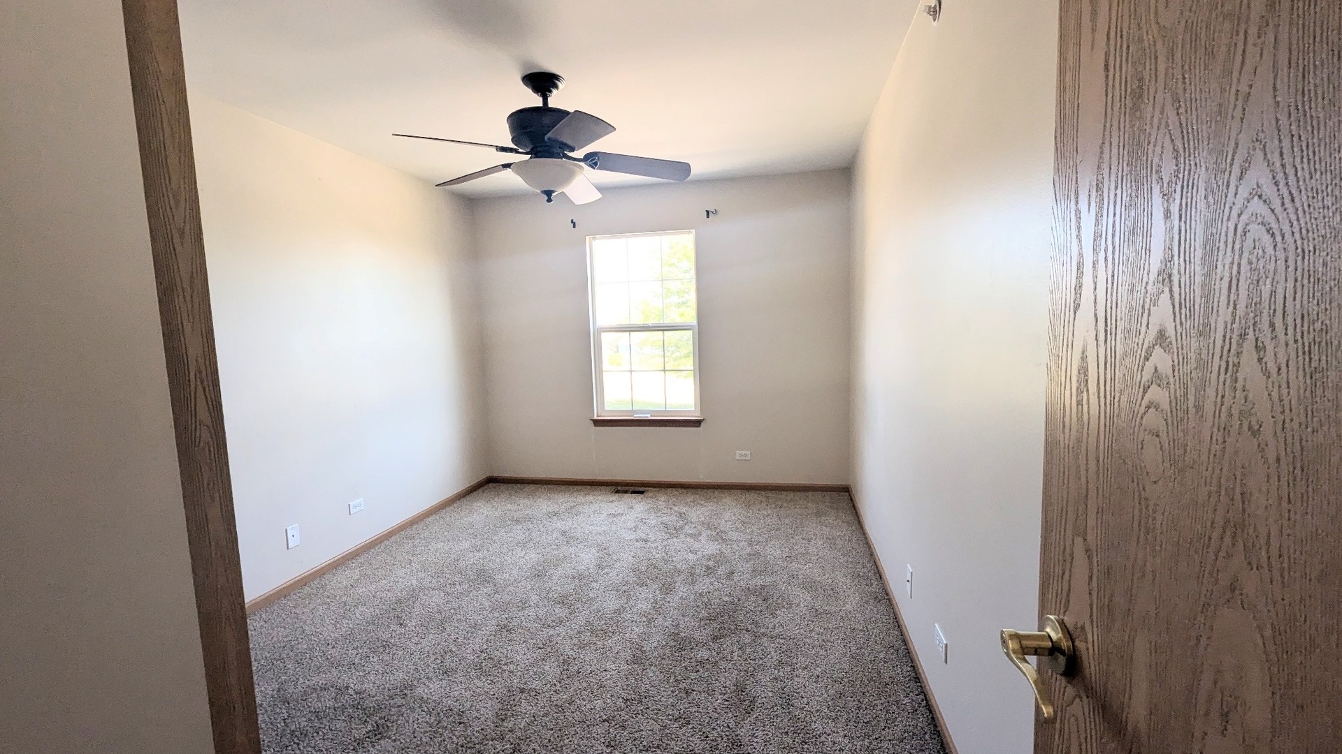 2075 Village View Drive Yorkville, IL 60560 - Photo 9 of 15 an empty room with windows and fan