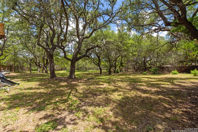 an aerial view of a house with a yard and outdoor seating