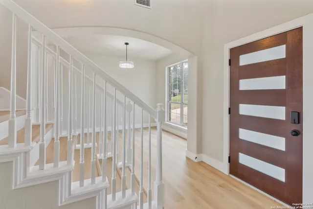 a view of a room with wooden floor and windows
