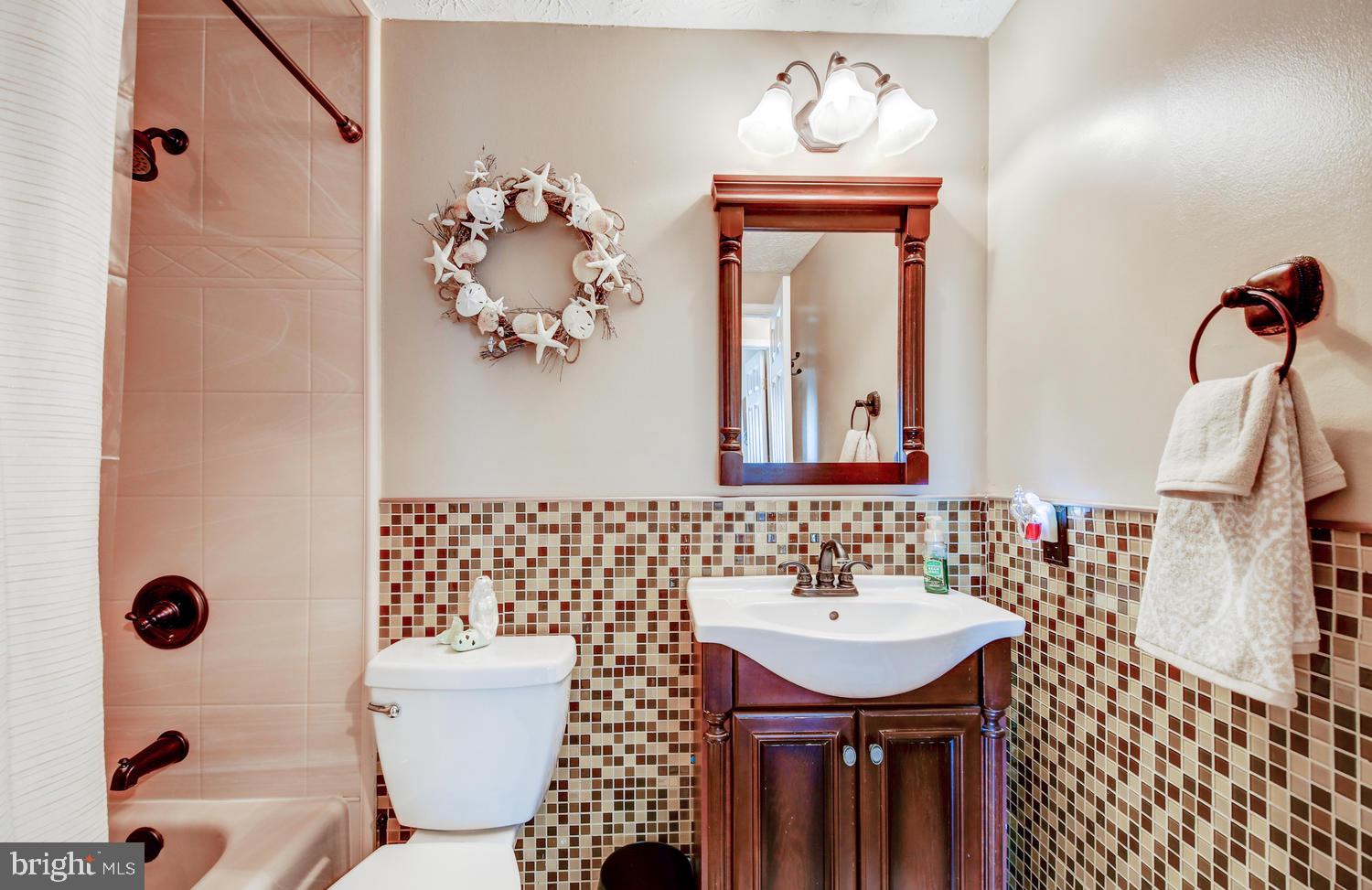 102 Sandhill Road Baltimore, MD 21221 - Photo 22 of 35 a bathroom with a sink a toilet and mirror