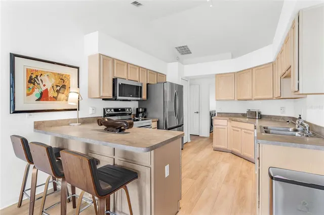 a kitchen with a refrigerator stove and microwave